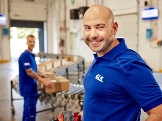GLS employee smiling at the camera